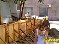 Fellow with camera is walking around the city and peeking under women skirts